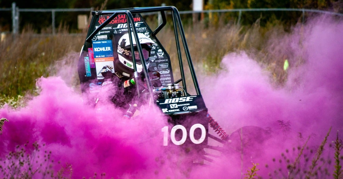 car driving through pink smoke